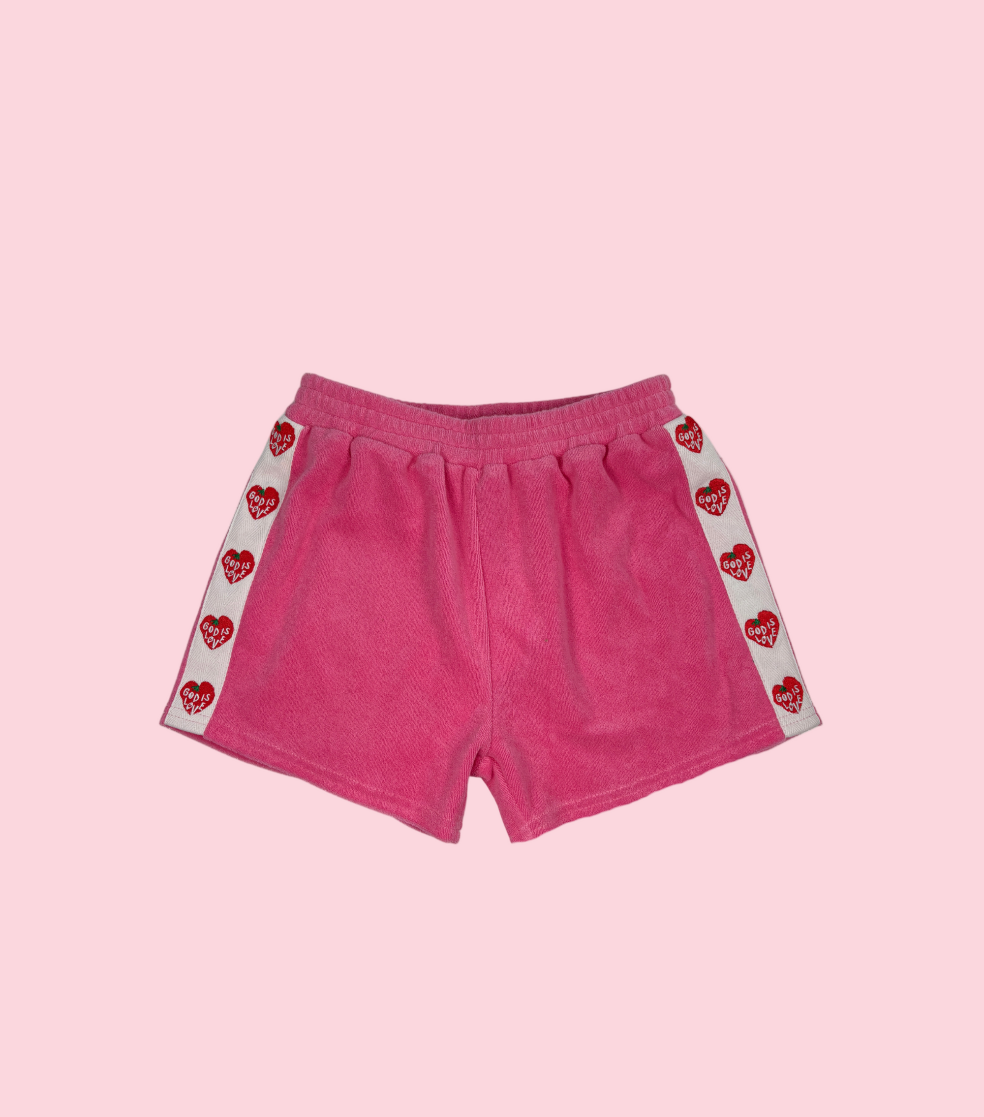 Pink shorts with red heart patterns on a white background
